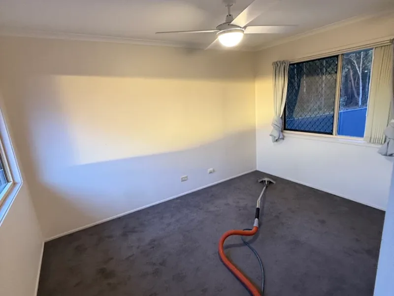 Spotless glass sliding doors and living room in a coastal Sunshine Coast residence