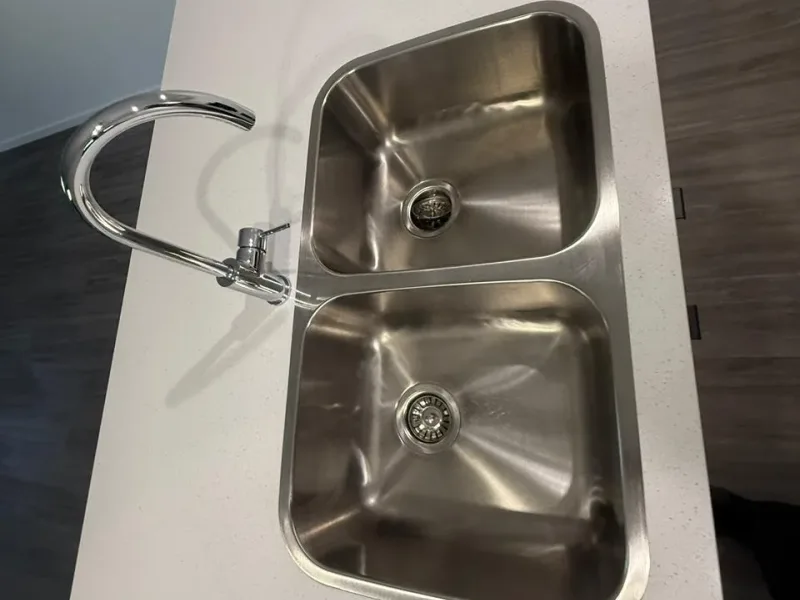 Sparkling bathroom vanity with polished chrome tapware and clean mirrors